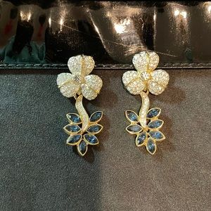 Vintage clip-on sparkly rhinestone flower earrings with blue leaf drops.